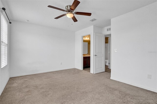 empty room with ceiling fan and light colored carpet