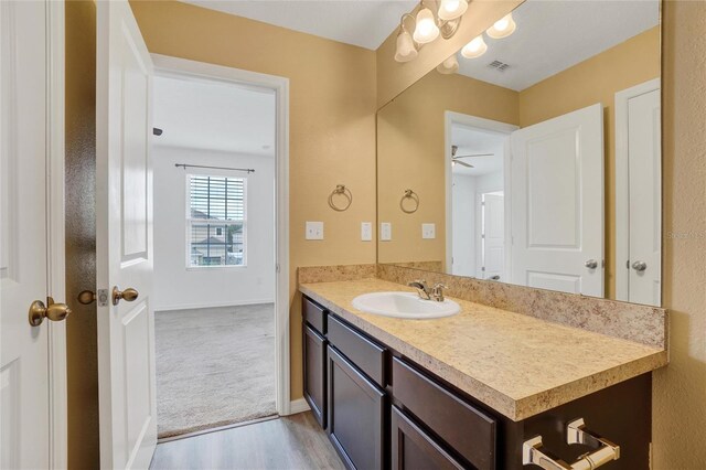 bathroom with vanity, hardwood / wood-style flooring, and ceiling fan