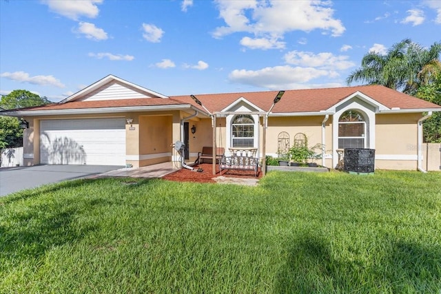 single story home featuring a garage and a front lawn