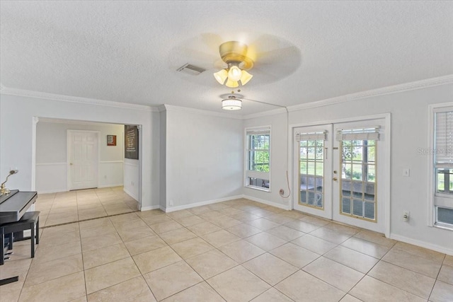 tiled empty room featuring crown molding, ceiling fan, french doors, and a textured ceiling