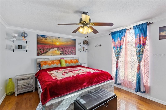 bedroom featuring crown molding, ceiling fan, a textured ceiling, and hardwood / wood-style flooring