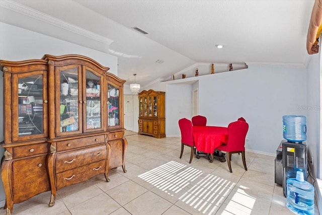 dining space featuring vaulted ceiling, light tile patterned floors, and crown molding