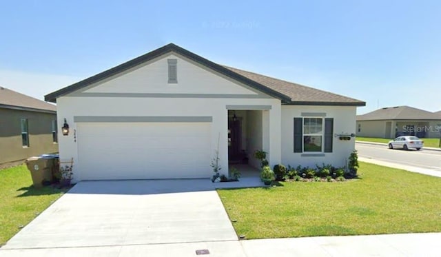 ranch-style home with a garage and a front yard