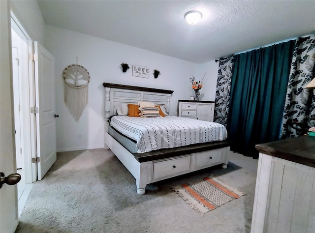 bedroom with a textured ceiling and carpet