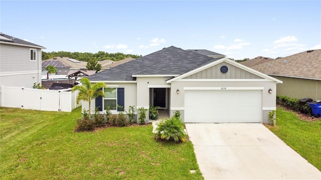 view of front of home with a front lawn and a garage