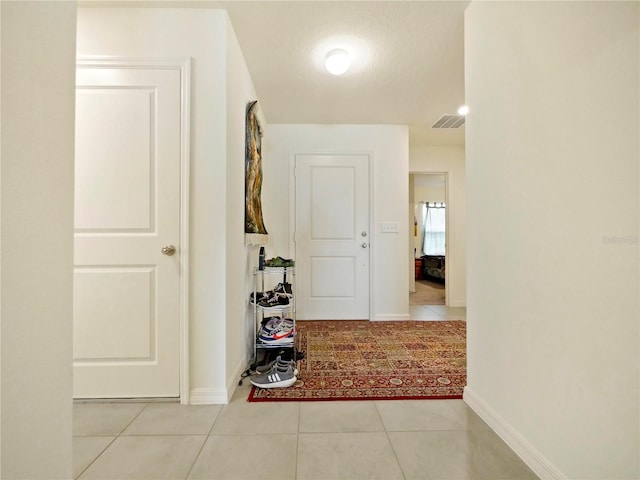 corridor featuring light tile patterned floors