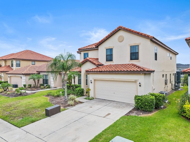 mediterranean / spanish house with a garage, central AC unit, and a front yard