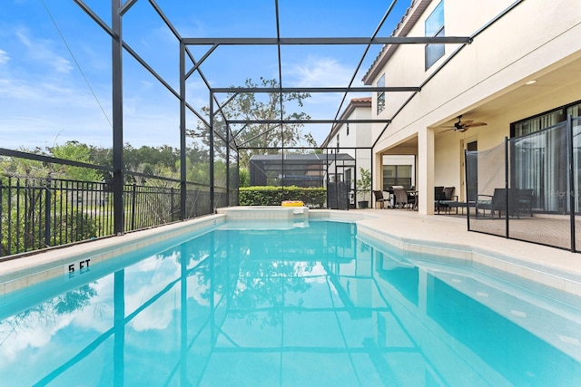 view of swimming pool featuring a patio, ceiling fan, and a lanai