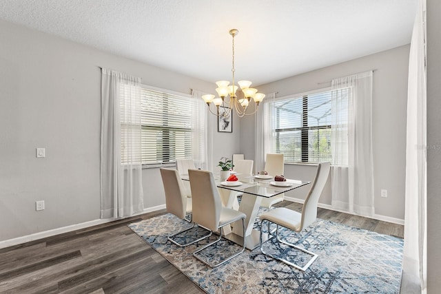 dining area featuring dark hardwood / wood-style flooring and a chandelier