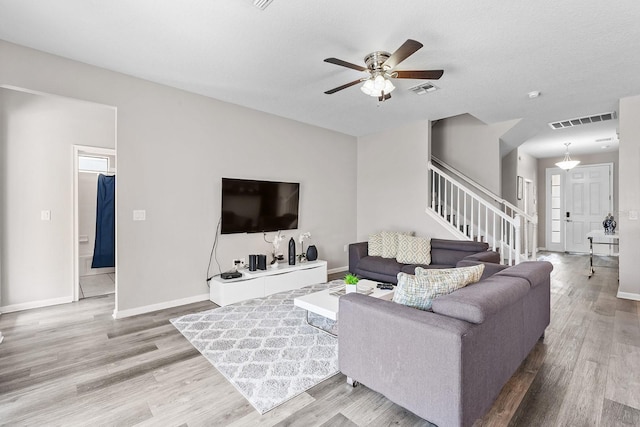 living room featuring light hardwood / wood-style floors and ceiling fan