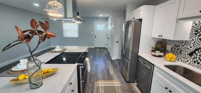 kitchen with white cabinetry, stainless steel appliances, pendant lighting, island exhaust hood, and dark wood-type flooring