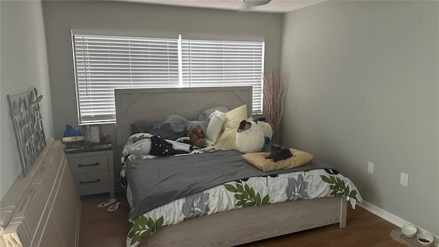 bedroom with dark wood-type flooring