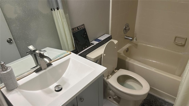 full bathroom with shower / bath combo with shower curtain, tile patterned flooring, vanity, and toilet