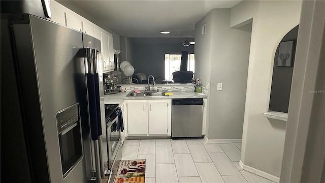 kitchen with white cabinetry, appliances with stainless steel finishes, tasteful backsplash, and sink