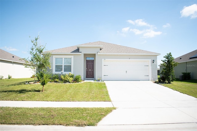 view of front facade with a garage and a front lawn