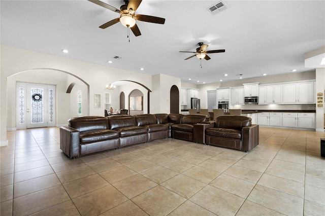 tiled living room featuring ceiling fan