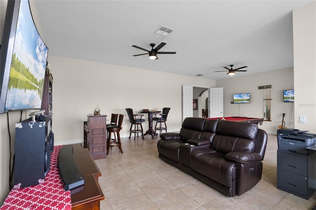 tiled living room featuring ceiling fan