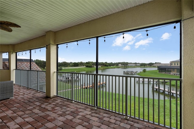 unfurnished sunroom featuring a water view