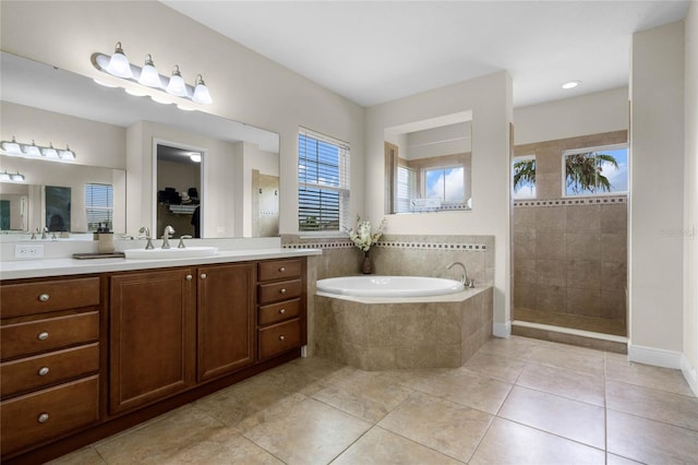 bathroom featuring plus walk in shower, tile patterned floors, and vanity