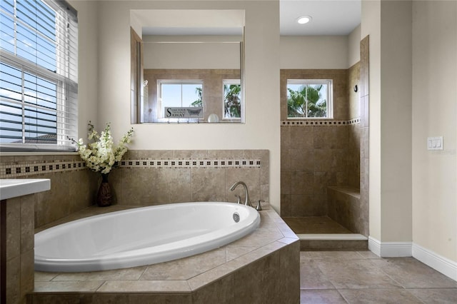 bathroom featuring independent shower and bath