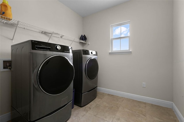 washroom with washing machine and clothes dryer