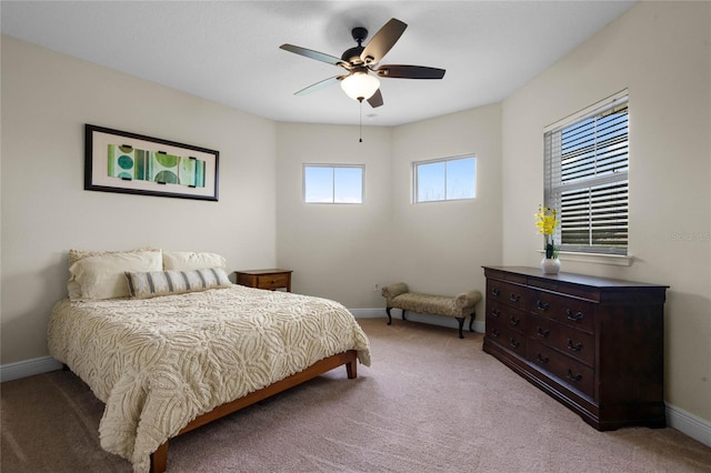 bedroom with ceiling fan, carpet flooring, and multiple windows