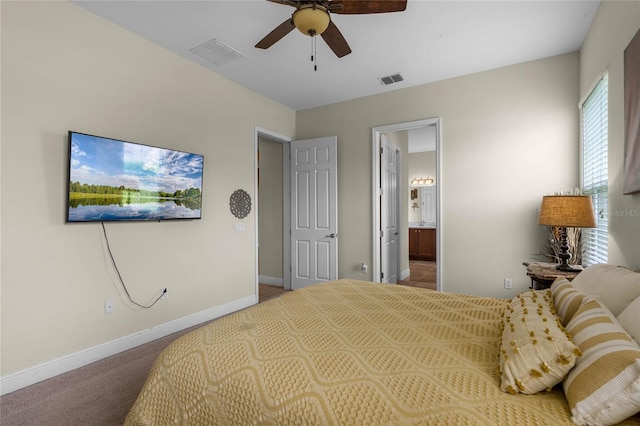 carpeted bedroom with ceiling fan and ensuite bath