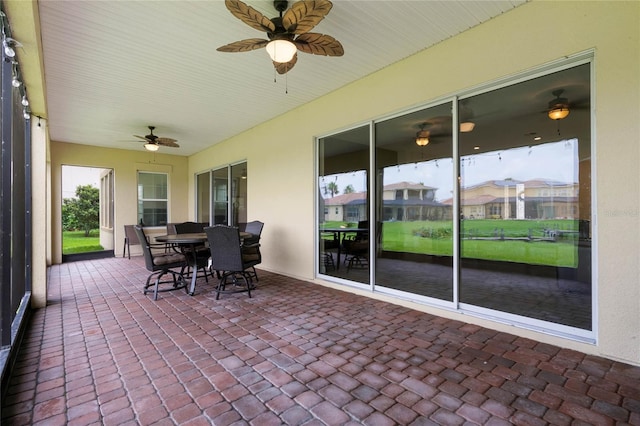 sunroom featuring ceiling fan