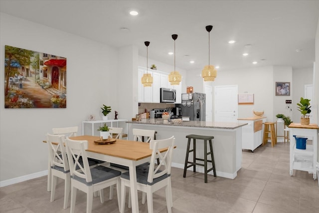 dining room with recessed lighting, baseboards, and light tile patterned floors