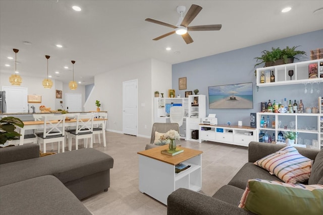 living room with baseboards, light tile patterned floors, a ceiling fan, and recessed lighting