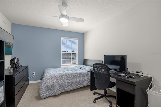 bedroom featuring ceiling fan, carpet floors, a textured ceiling, and baseboards