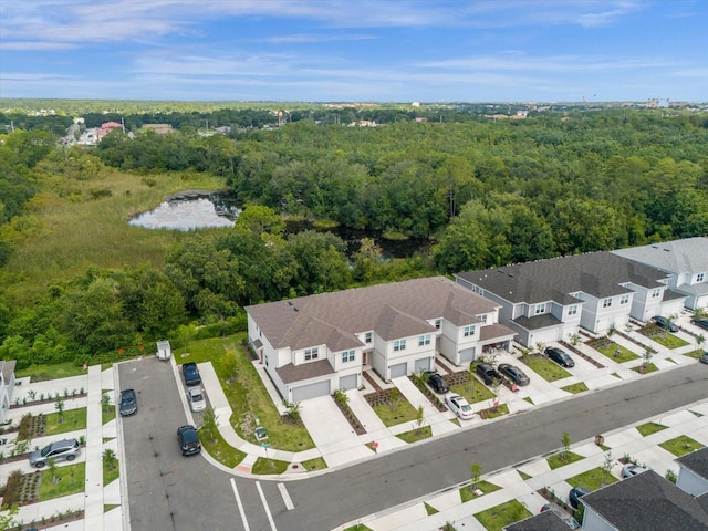 bird's eye view featuring a water view, a residential view, and a view of trees