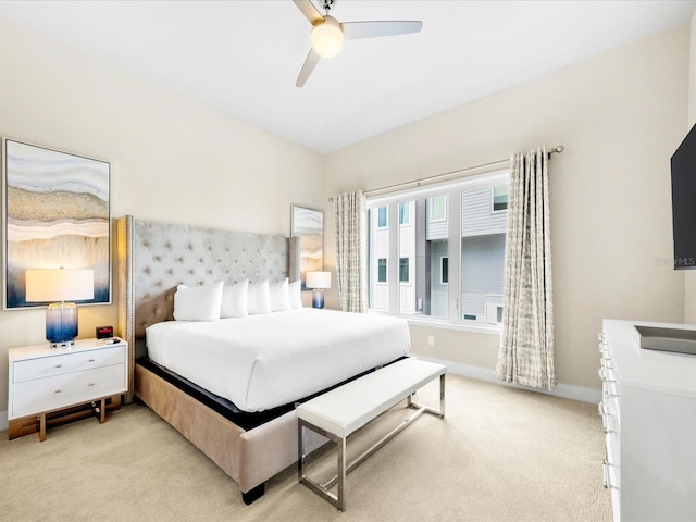 bedroom featuring light carpet and ceiling fan