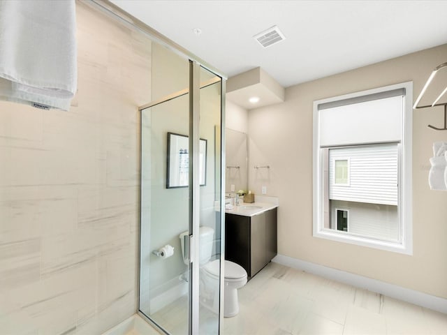 bathroom featuring a shower with door, tile patterned floors, toilet, and vanity