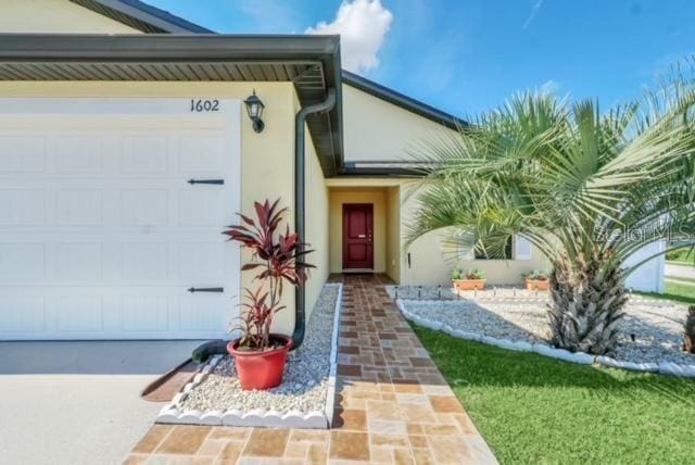 view of exterior entry with a garage