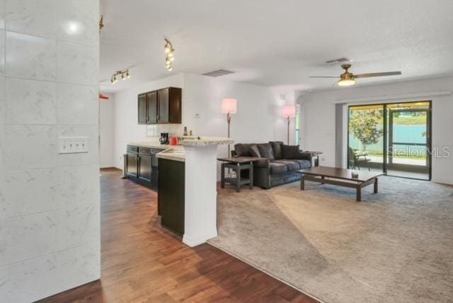 living room with dark hardwood / wood-style floors and ceiling fan