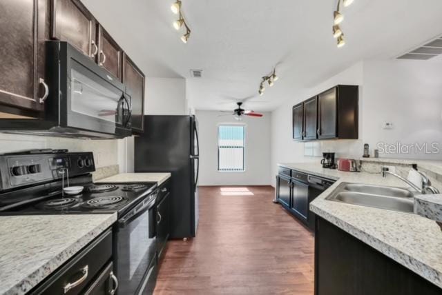 kitchen with dark hardwood / wood-style floors, sink, dark brown cabinetry, and black appliances