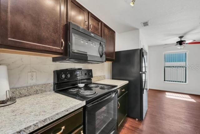 kitchen featuring dark wood-type flooring, ceiling fan, backsplash, dark brown cabinetry, and black appliances