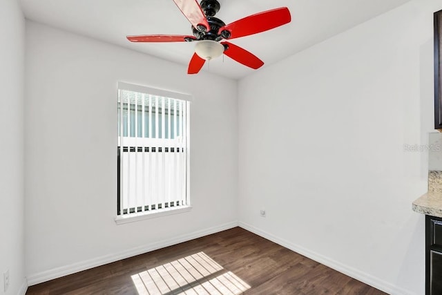 unfurnished room with dark hardwood / wood-style floors and ceiling fan