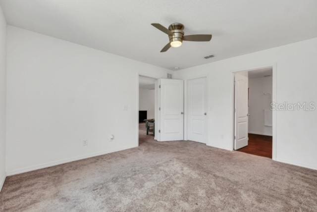 unfurnished bedroom with ceiling fan and carpet flooring