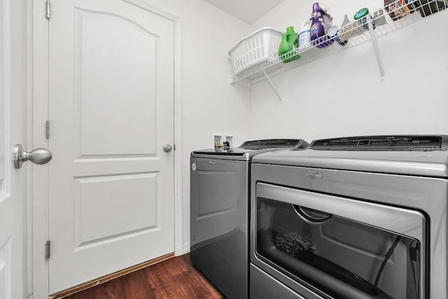 laundry room with washer and dryer and dark hardwood / wood-style floors