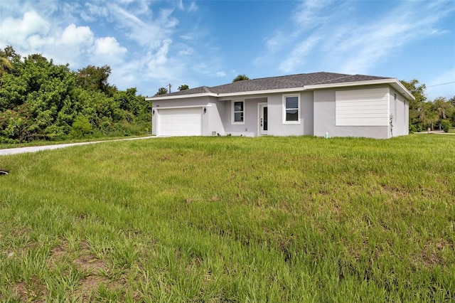 ranch-style home featuring a garage and a front lawn