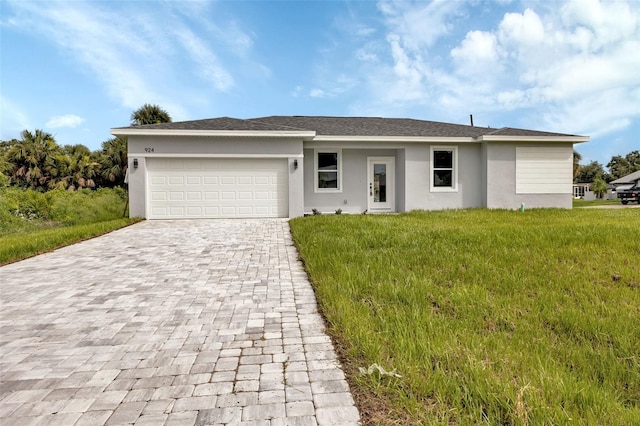 ranch-style house with a garage and a front yard