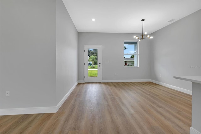 interior space with a chandelier and light hardwood / wood-style flooring