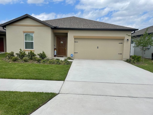 view of front of home featuring a garage and a front yard