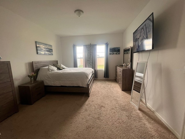 bedroom featuring light colored carpet