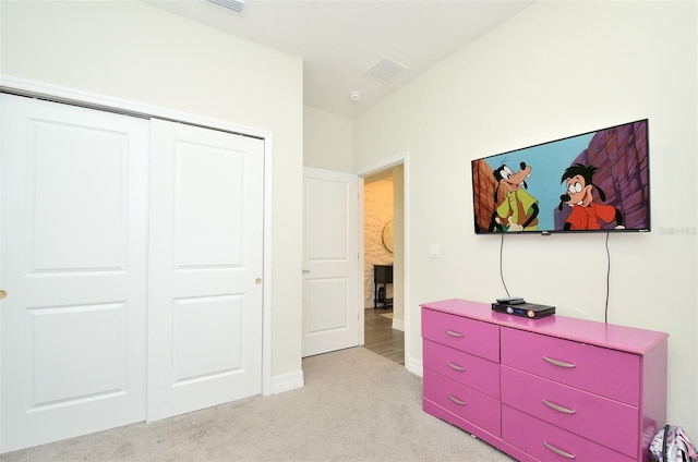 carpeted bedroom featuring a closet