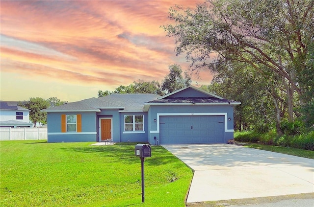 single story home with a lawn and a garage