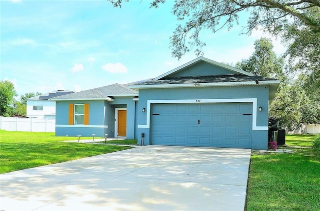 view of front of property featuring a front lawn and a garage