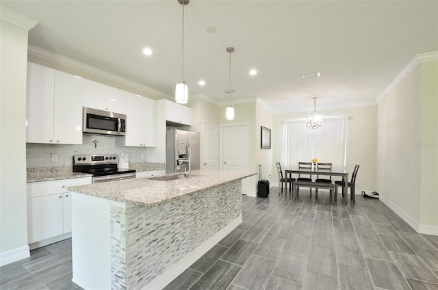 kitchen featuring white cabinetry, an island with sink, and stainless steel appliances